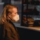 customer in respiratory mask against bakery counter