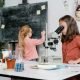 a smart girl using a microscope