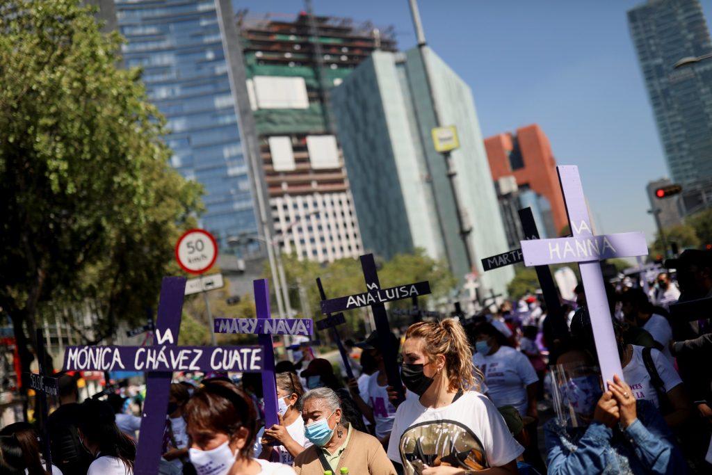 Clutching graveyard crosses, hundreds protest violence against women in Mexico