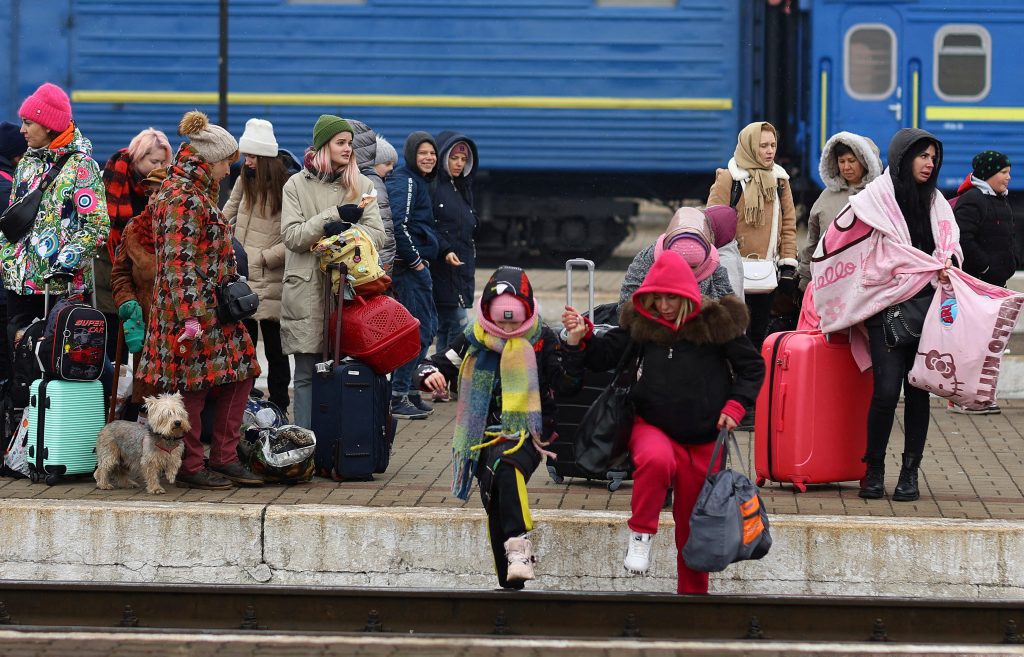 Tearful Ukrainians in Lviv wait for hours to board trains, fleeing Russian attacks