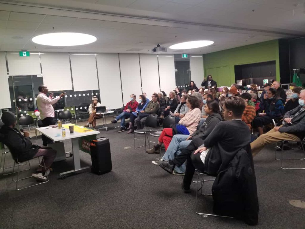 Author Gabriel Allahdua speaks to community members and students in Halifax about migrant worker rights