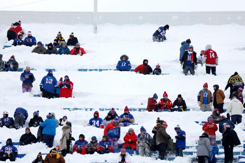 Buffalo Bills fans work hard and play hard while shovelling snow at stadium