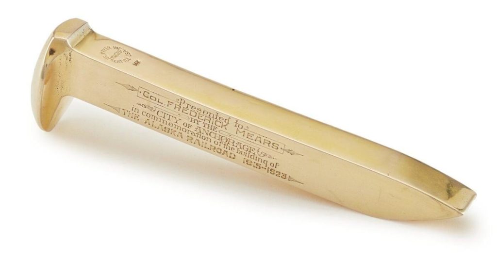 A golden spike that completed the Alaska Railroad is up for auction. Alaskans want to bring it home