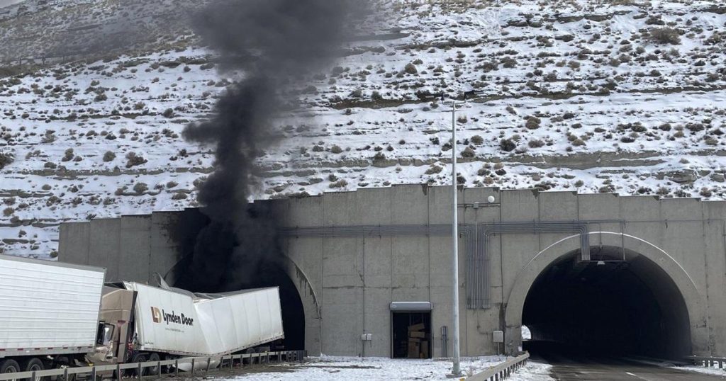 Investigators enter a highway tunnel in Wyoming where a fiery crash killed 2