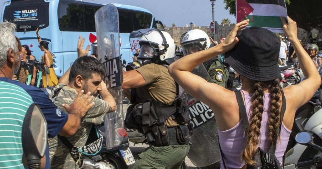 Riot police scuffle with demonstrators on Greek island during visit by Israeli cruise ship
