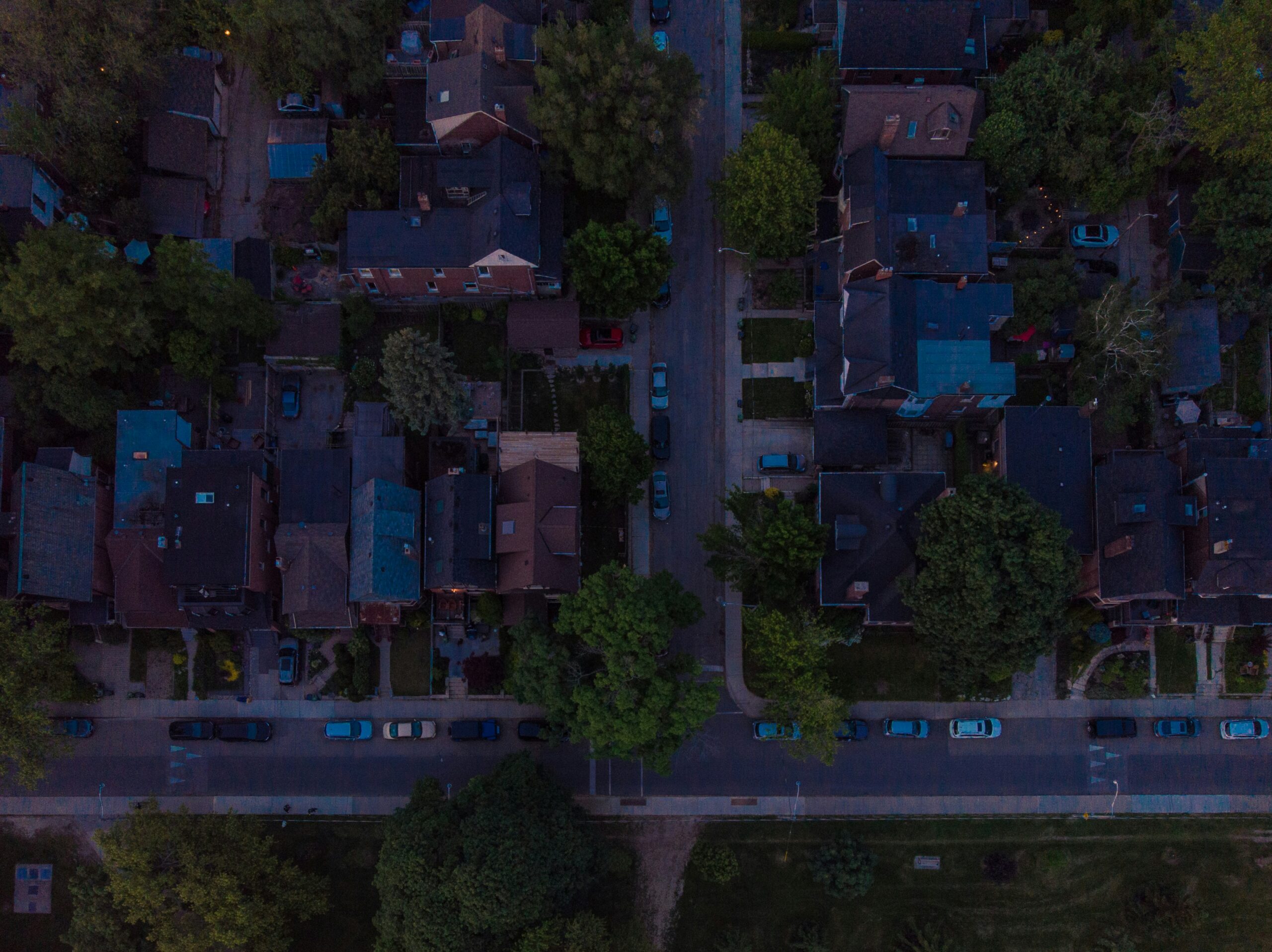 Aerial photography of a residential neighbourhood surrounded by trees