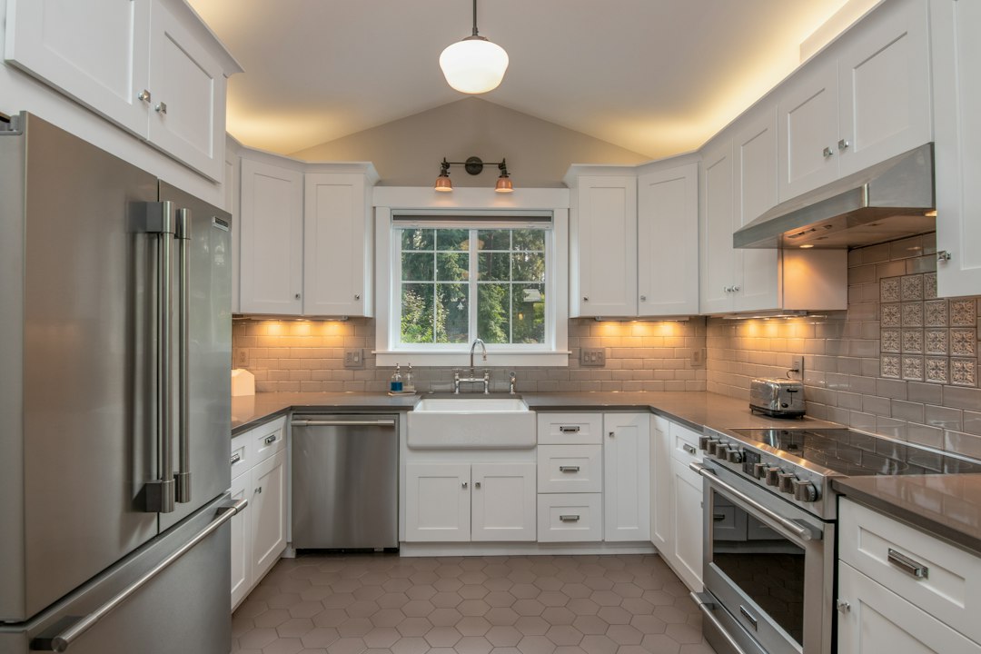 Apartment-sized kitchen with stainless steel appliances (illustrative stock photo)