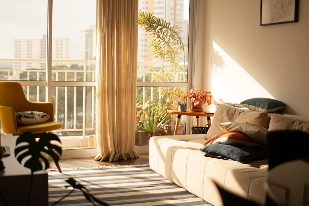 Sunlit apartment living room with modern furnishings (illustrative stock photo)
