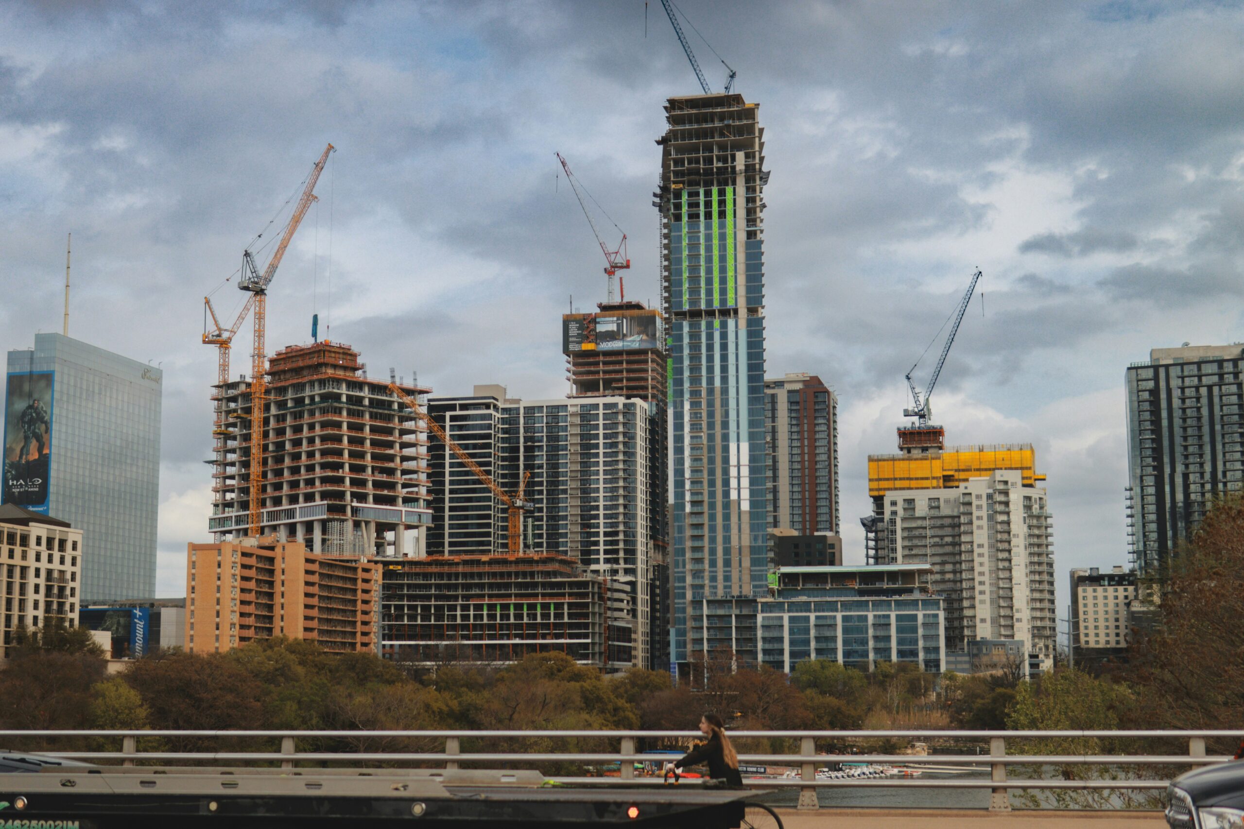 City skyline under construction with cranes, illustrative stock photo