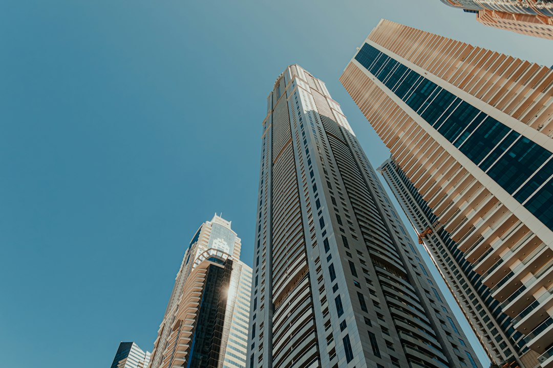 Modern high-rise towers against a blue sky (illustrative stock photo)