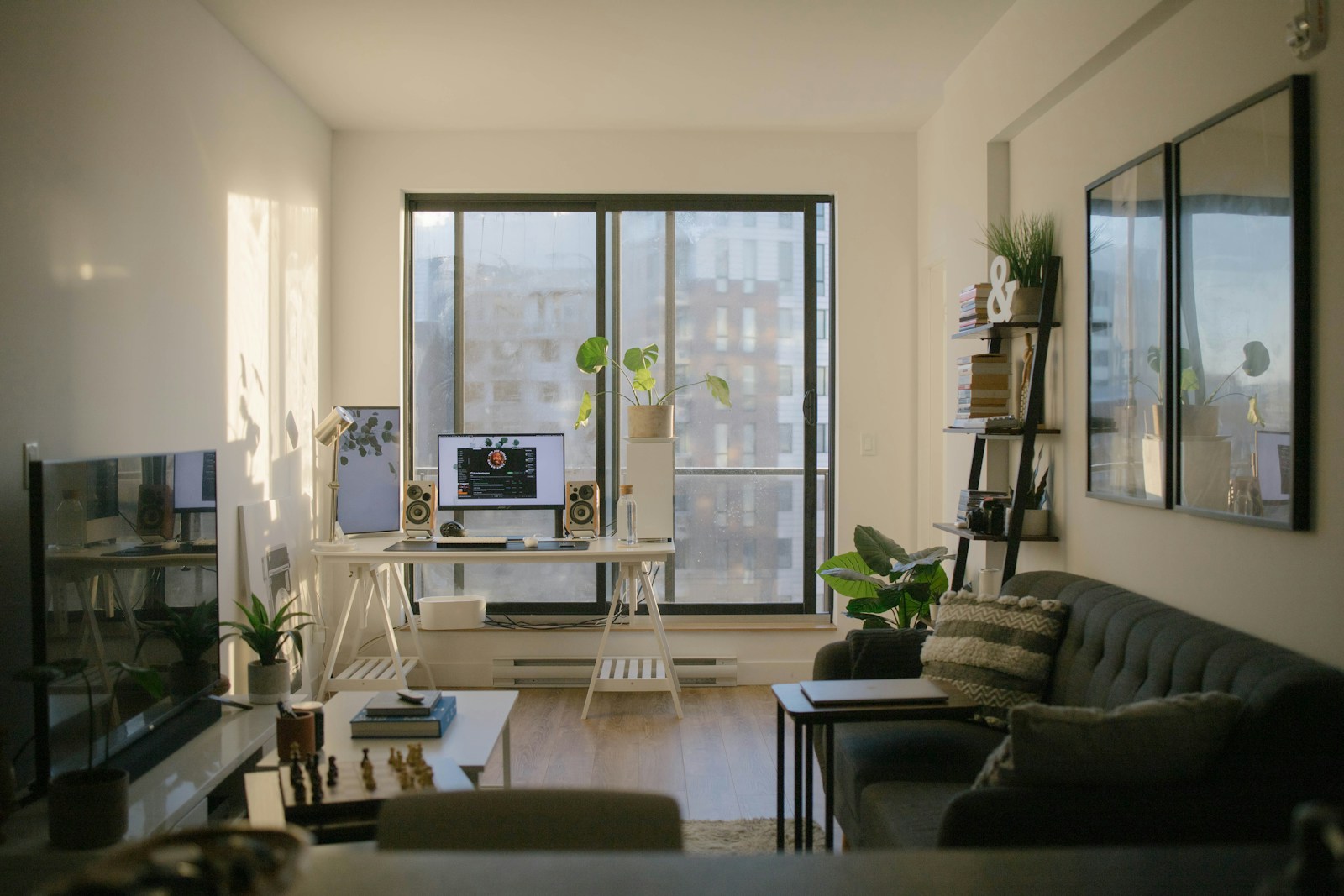 Living area of a small condominium apartment with sofa and window light