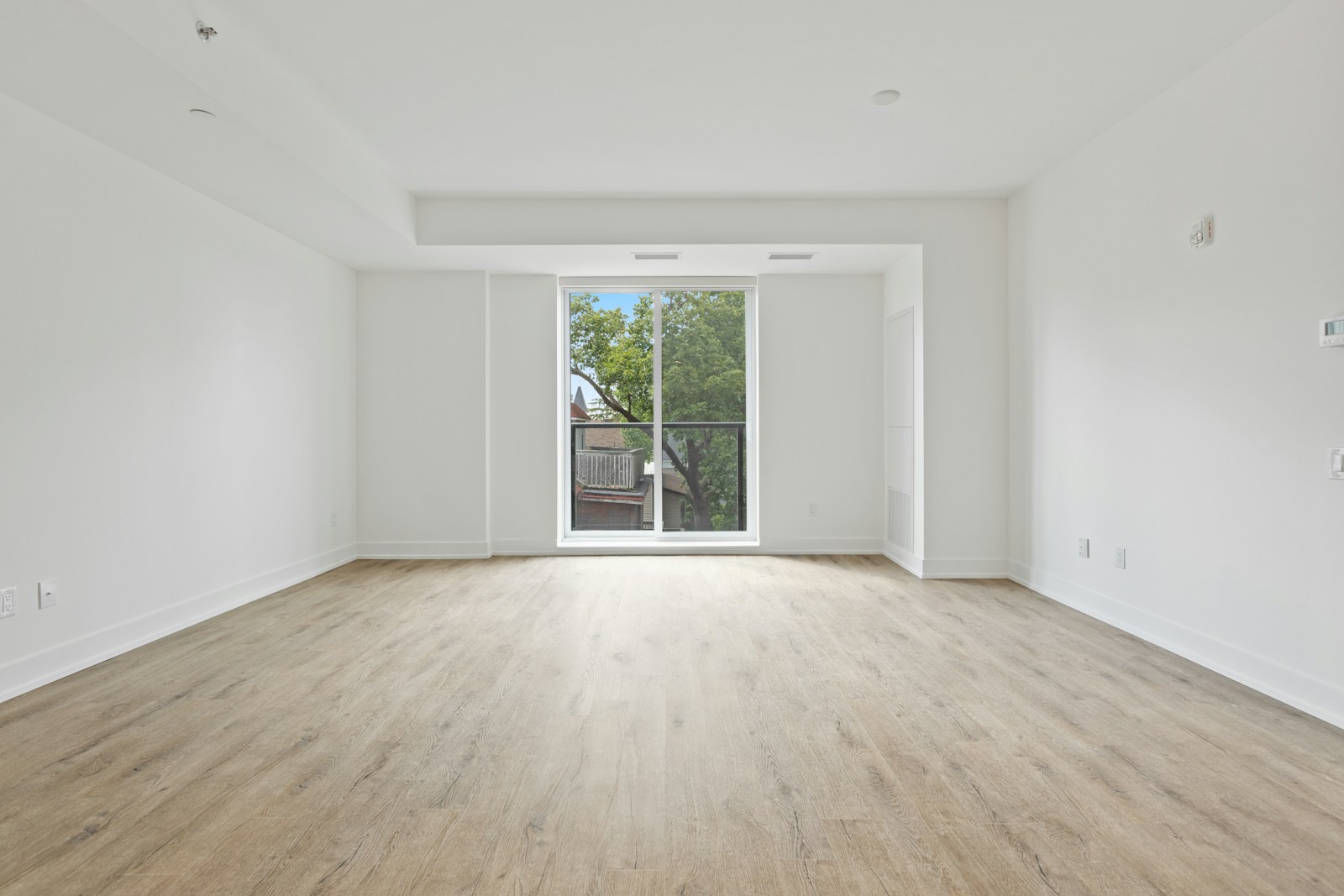Stock photograph of an empty condominium unit with a balcony door