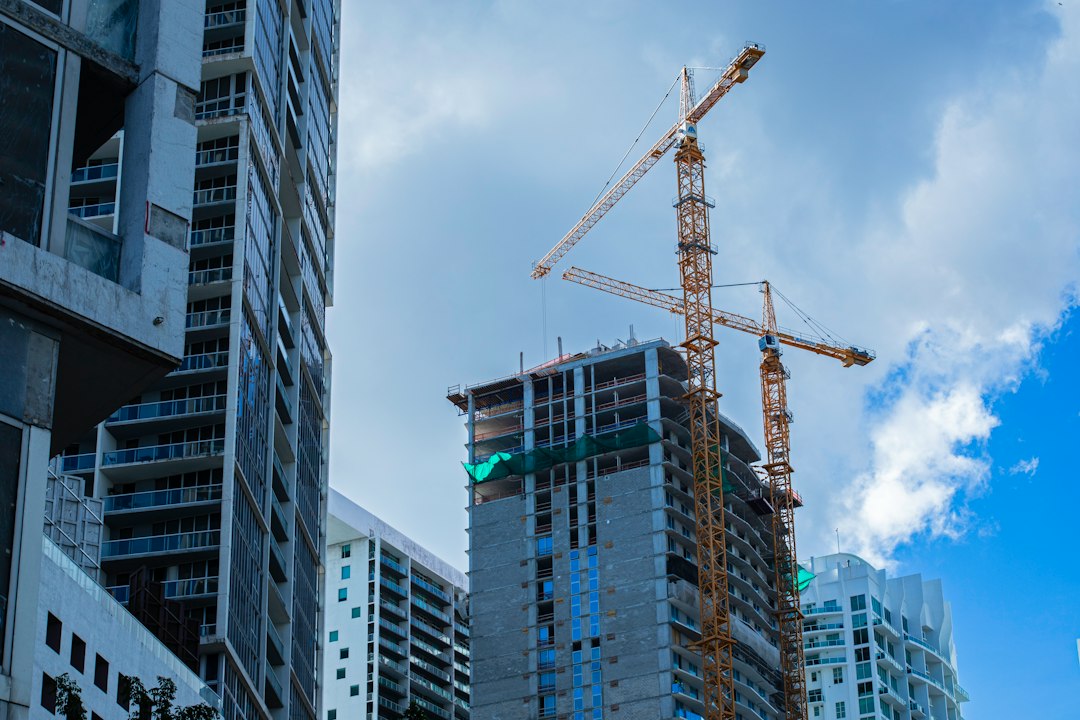 Construction cranes rise over highrise apartment towers under construction in a Canadian city