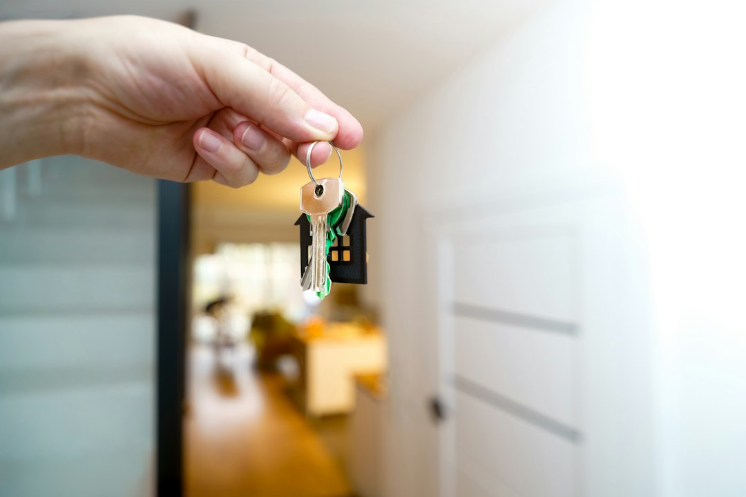 A hand holding a new home's door key. Illustrative stock photo.