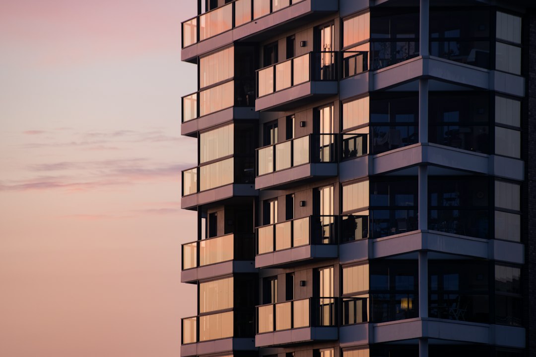 Modern apartment building exterior with glass balconies