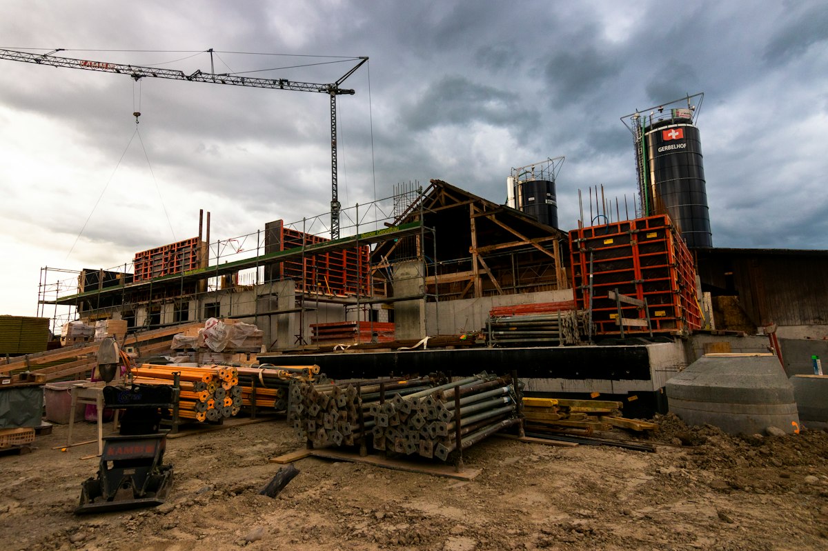 Residential building under construction with scaffolding and equipment