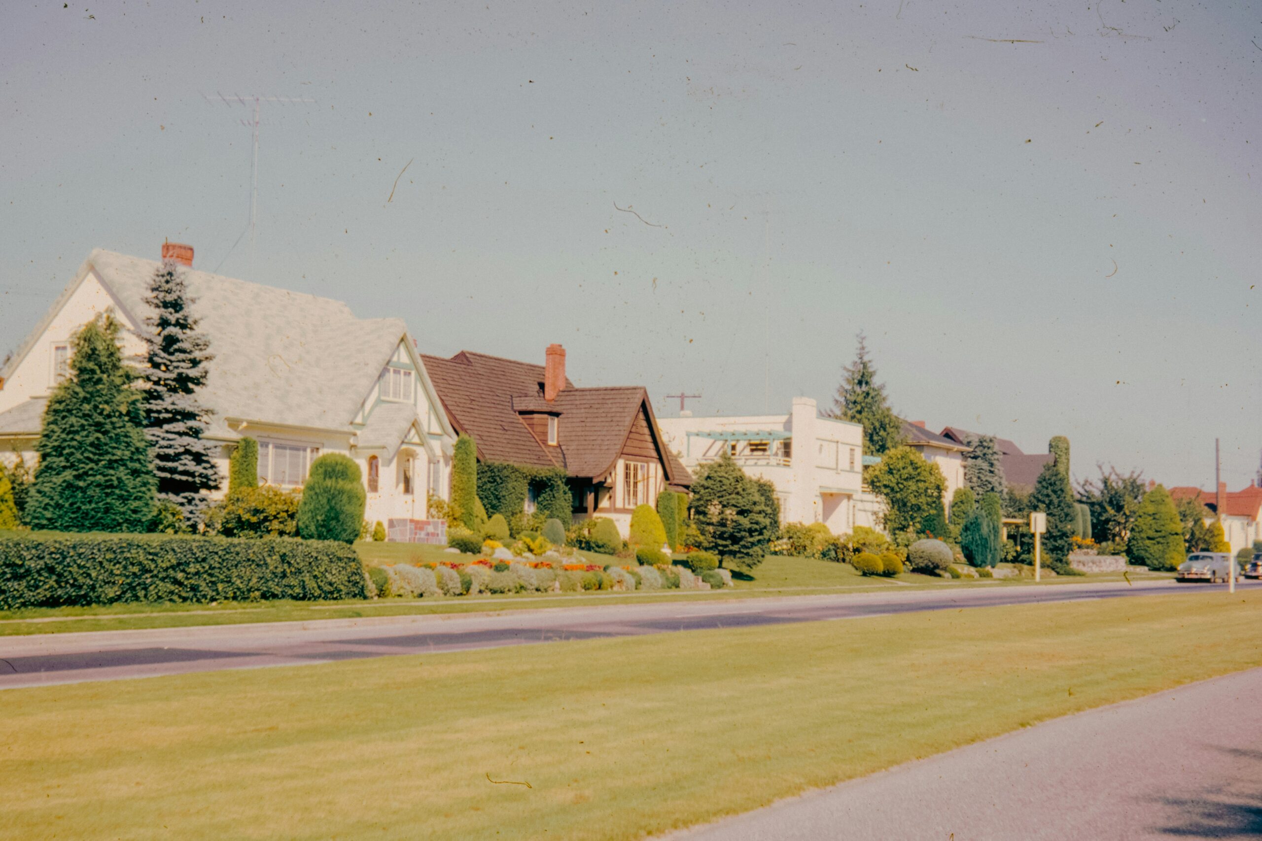 A row of ground-oriented detached houses along a residential street