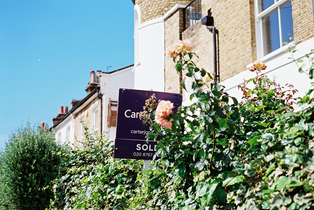 A sold sign in front of a house, illustrative stock photo