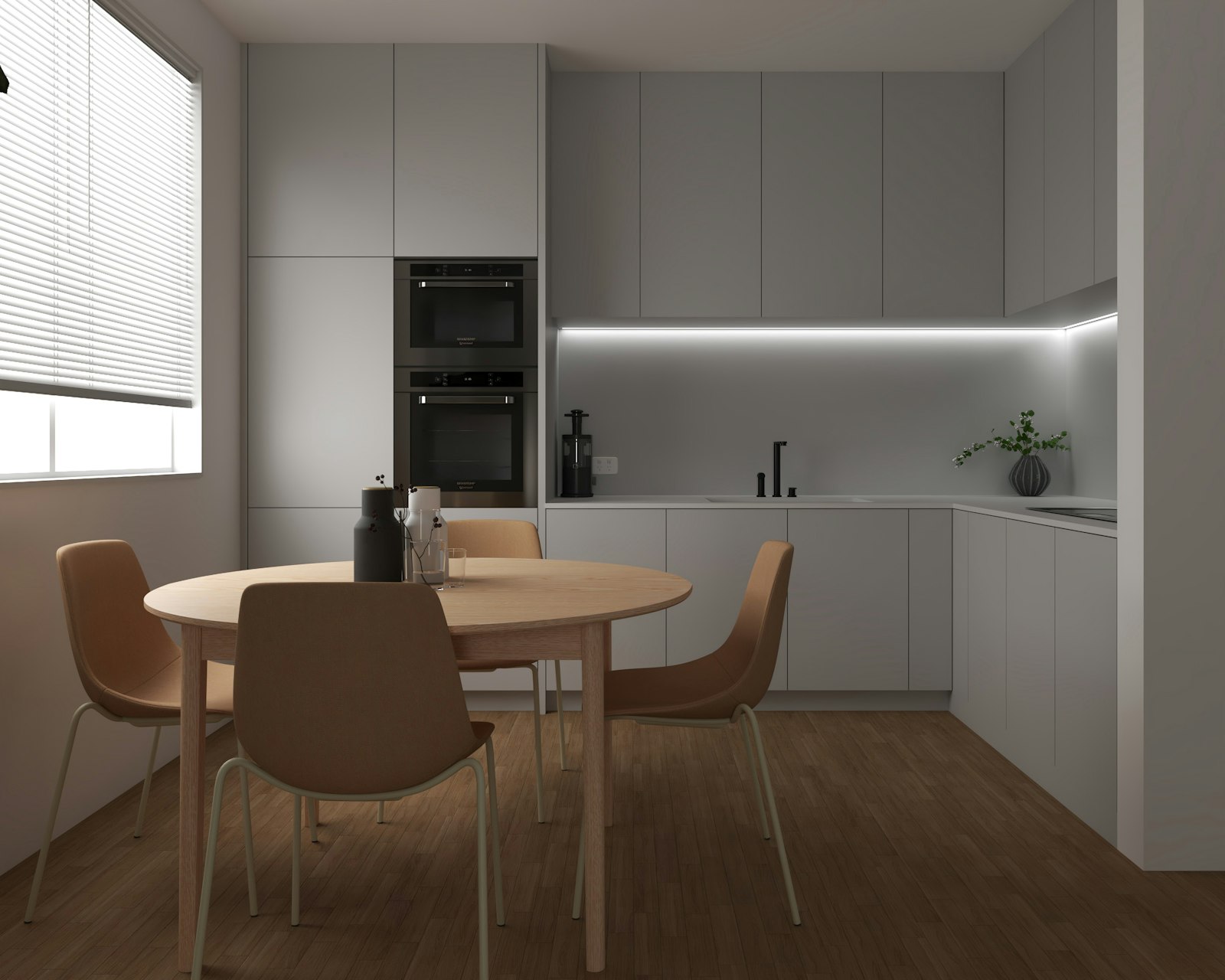 Apartment kitchen with a table and chairs beside a window