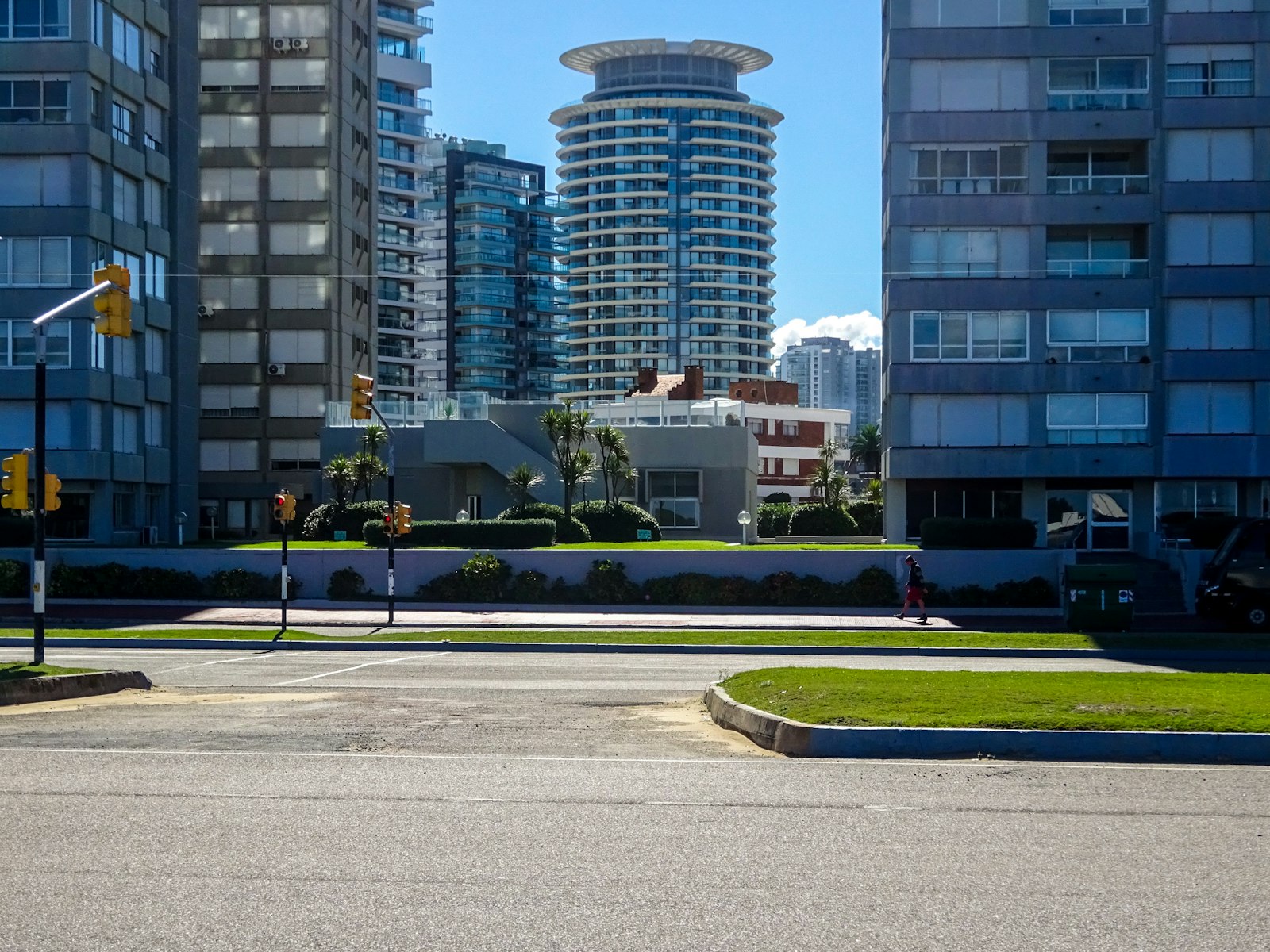 Modern residential buildings along a city street on a sunny day