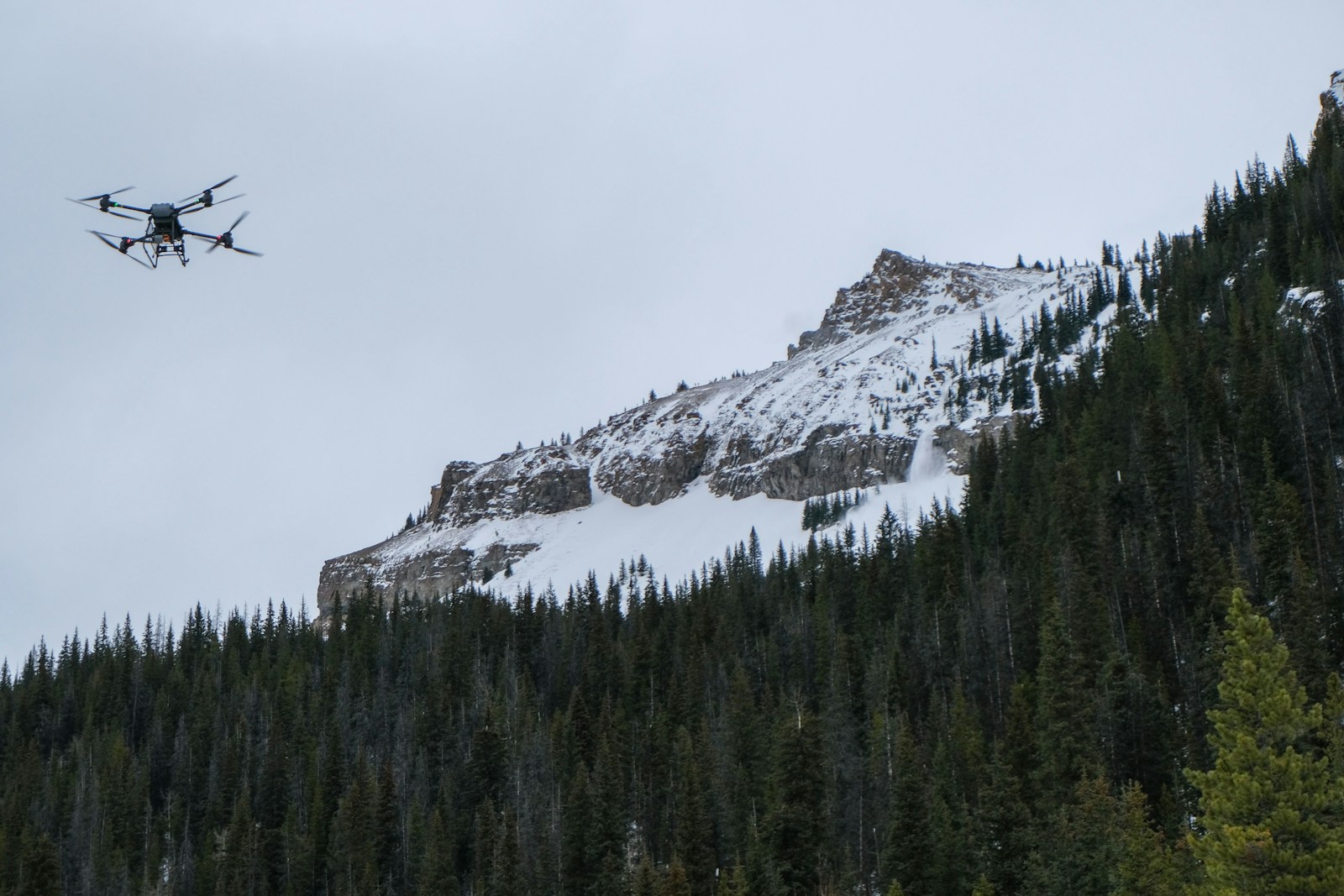 Compact camera drone flying over the Rocky Mountains
