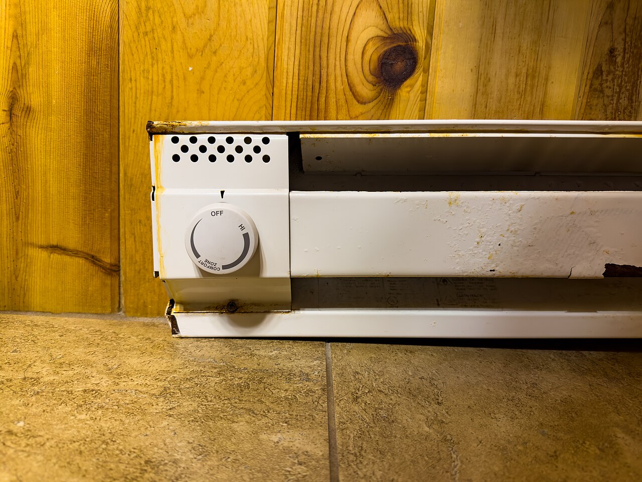An electric baseboard heater on a wall