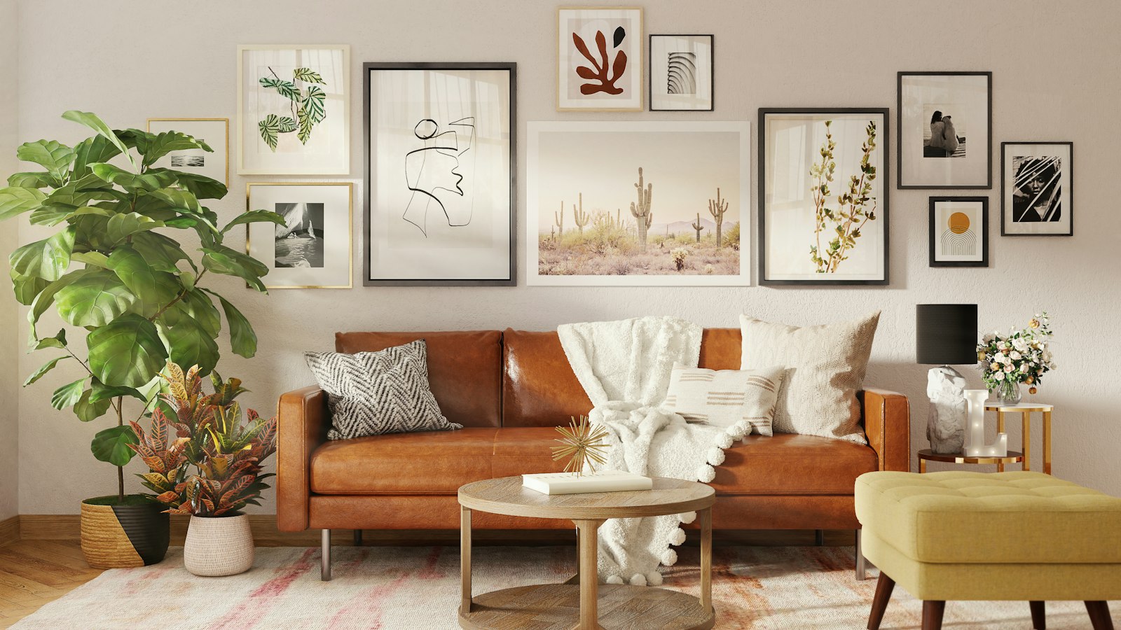 Gallery wall of framed prints above a brown leather sofa