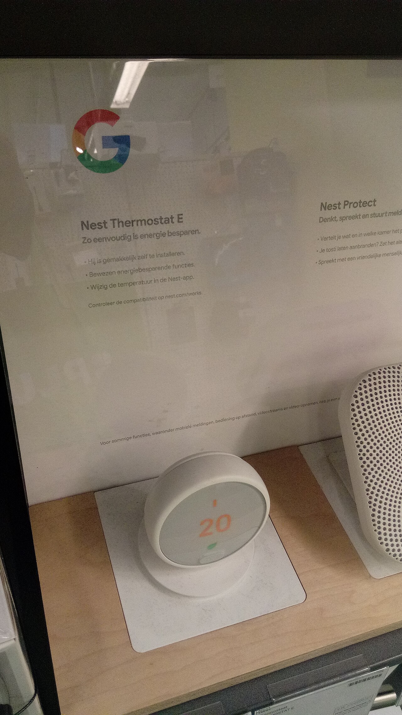 A Google Nest Thermostat E mounted on a wall