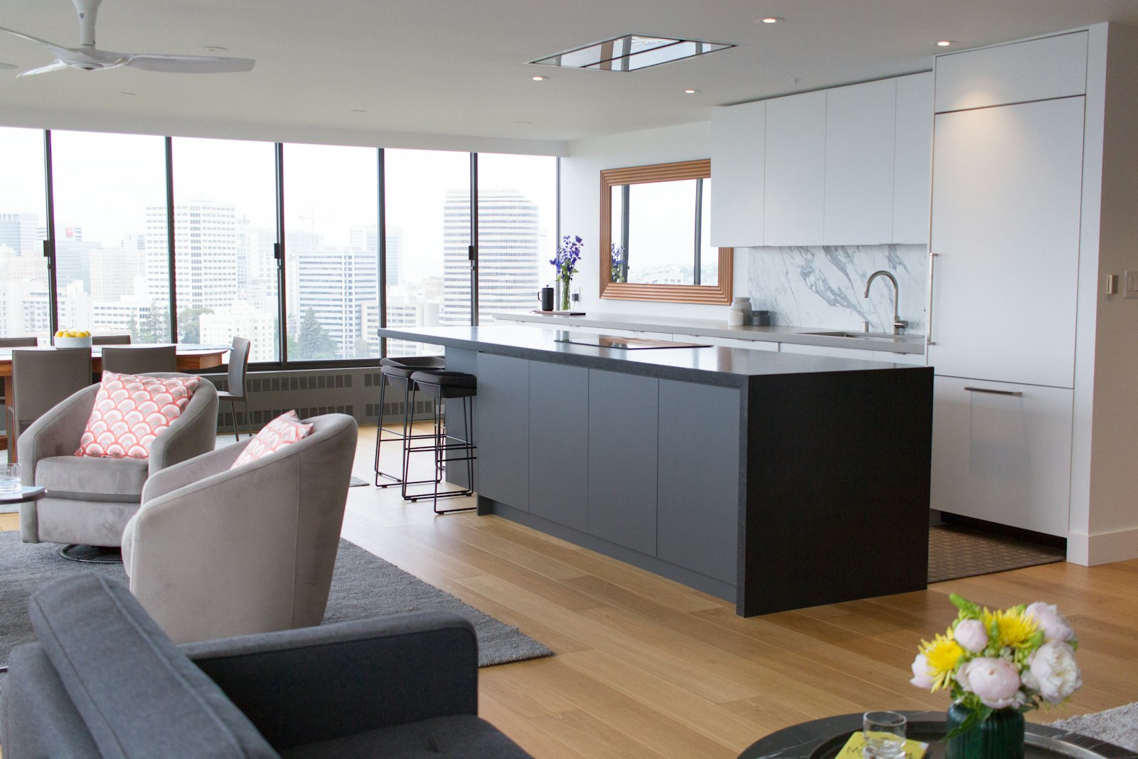 Sunlit living room open to a kitchen