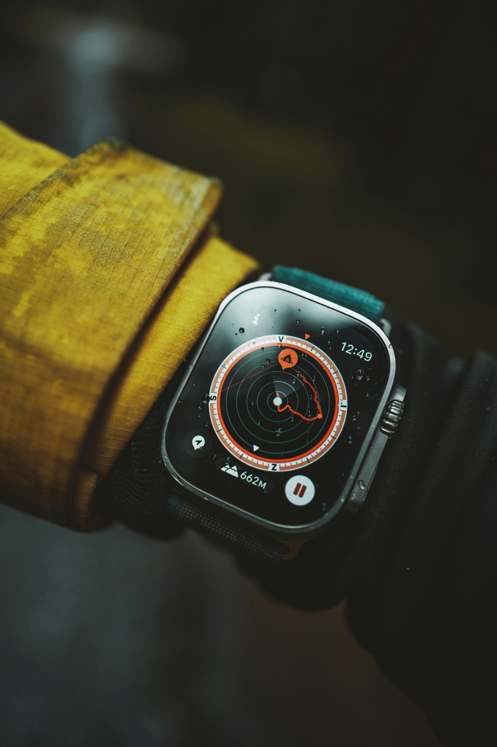 Apple Watch Ultra showing a compass and route-tracking screen on a hiker's wrist