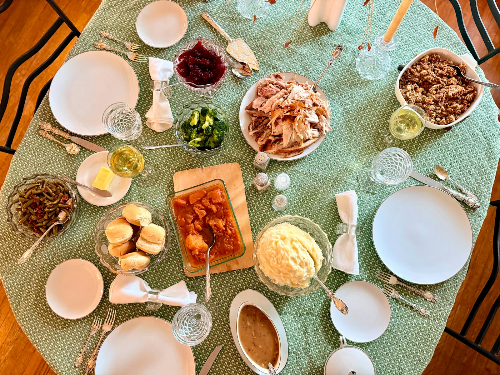 A fall dinner table full of food for a large gathering