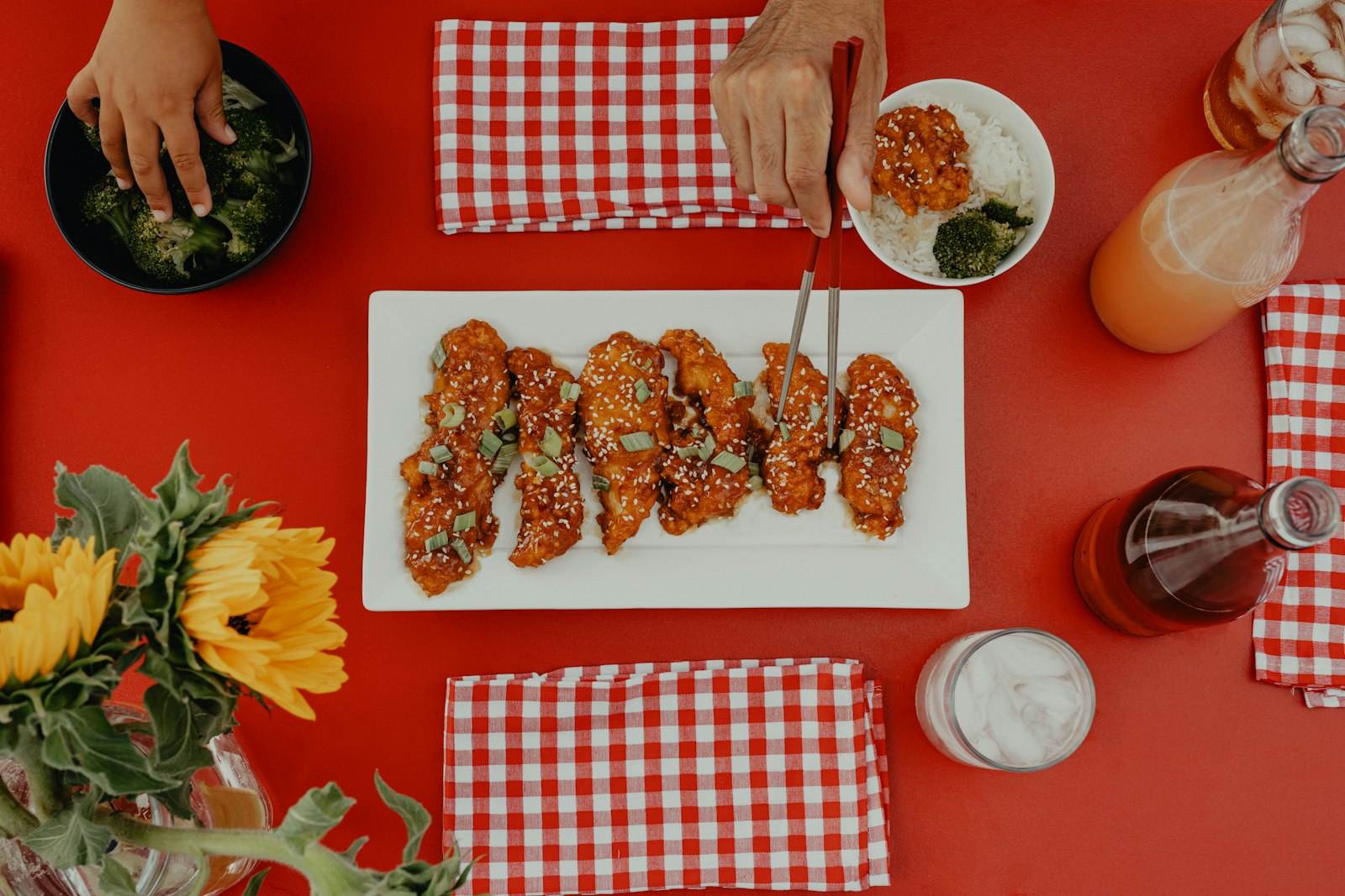 Glazed chicken wings on a white platter with dipping sauce
