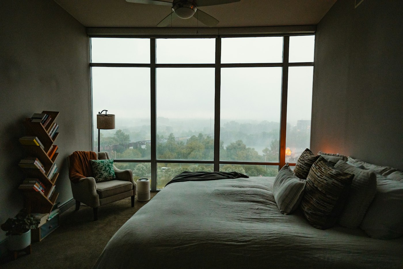 Bedroom with a large window and a bed, where a cool mist humidifier could ease dry winter air