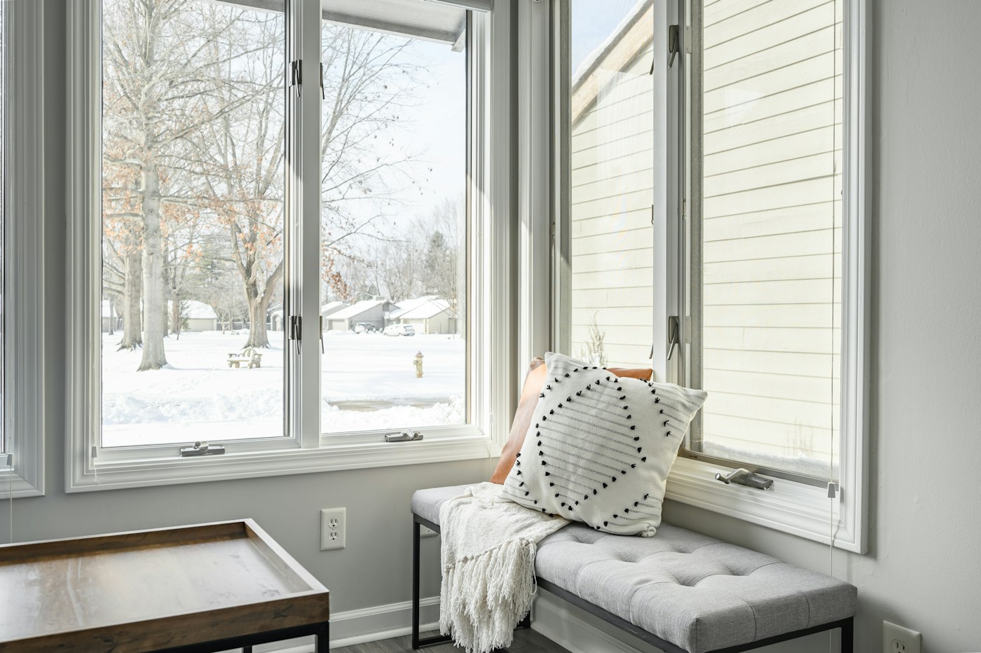 Window seat with a pillow in front of a window, a quiet corner for a small humidifier