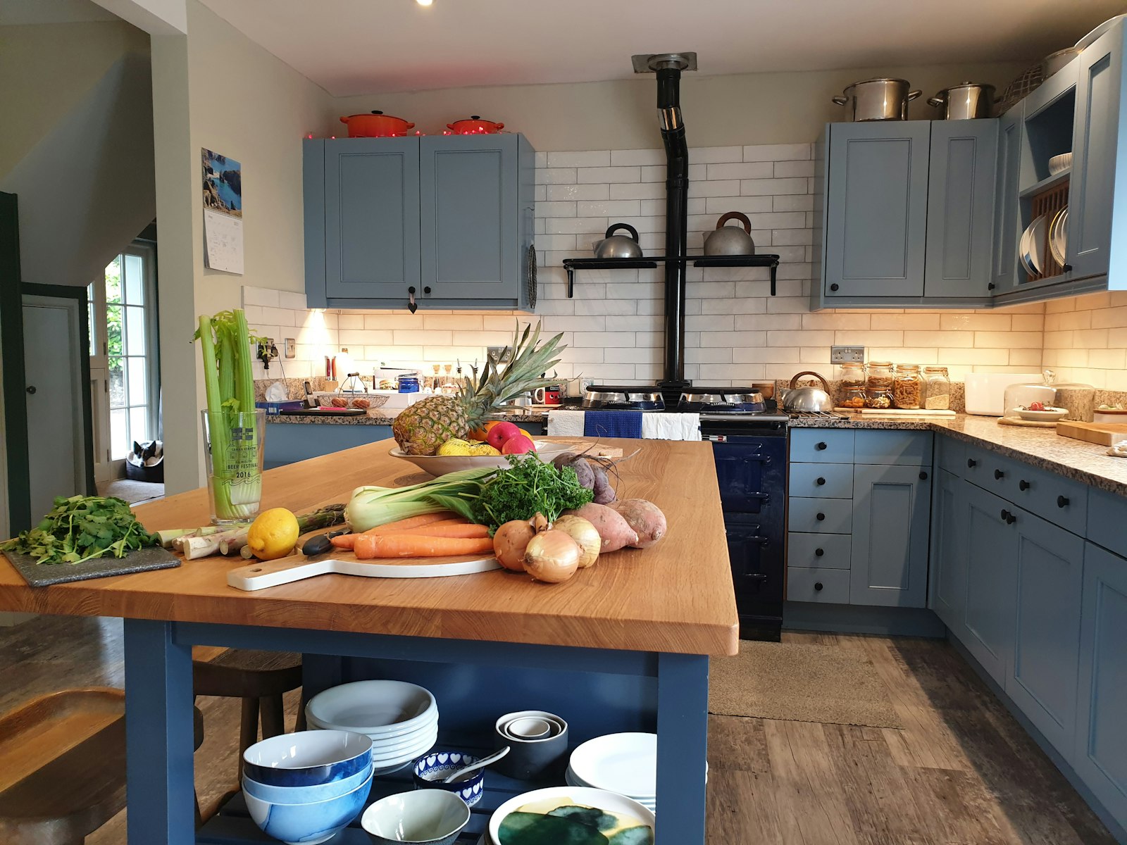 A kitchen table covered in fresh vegetables ready for a slow-cooker meal