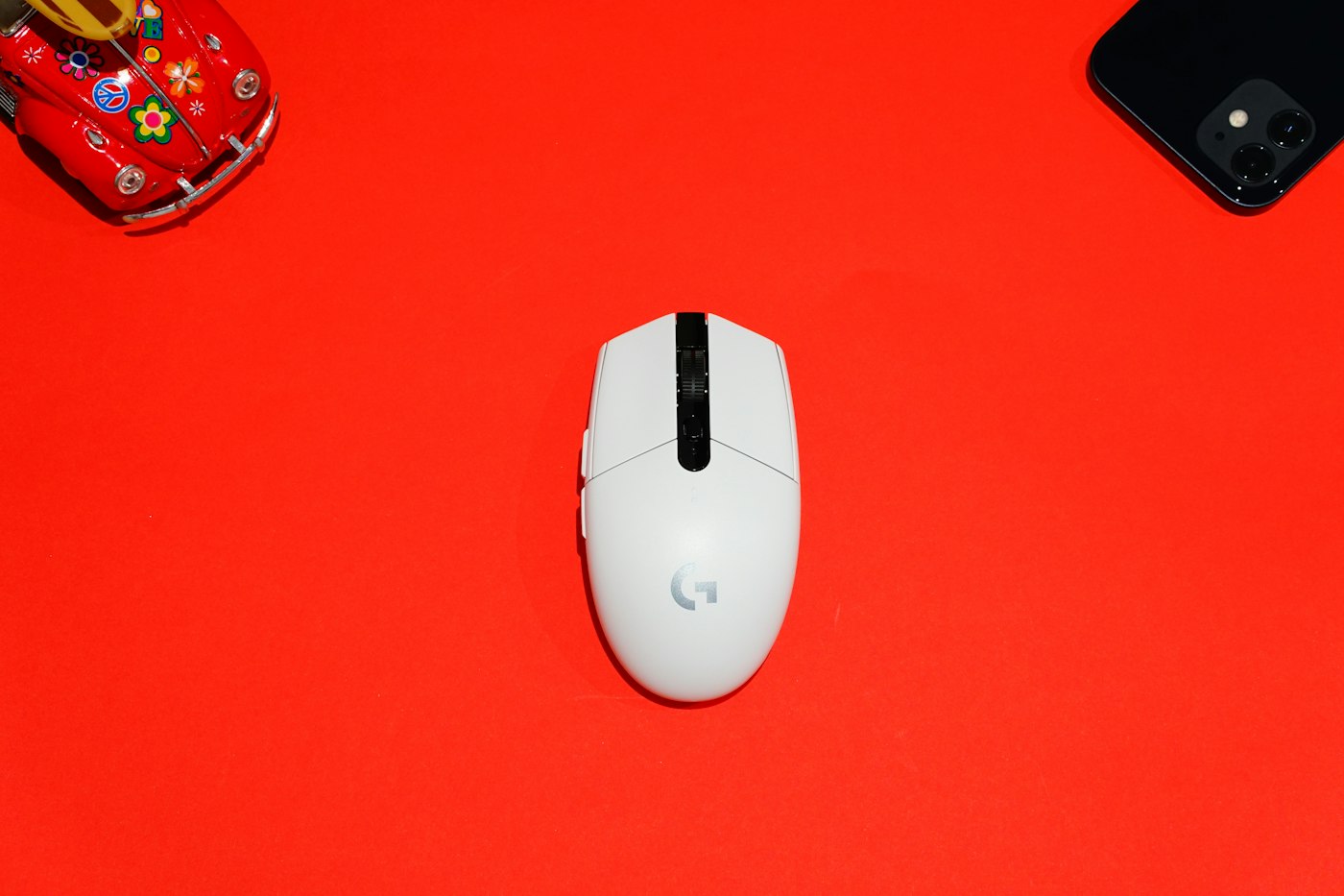 Logitech wireless gaming mouse seen from above on a red background