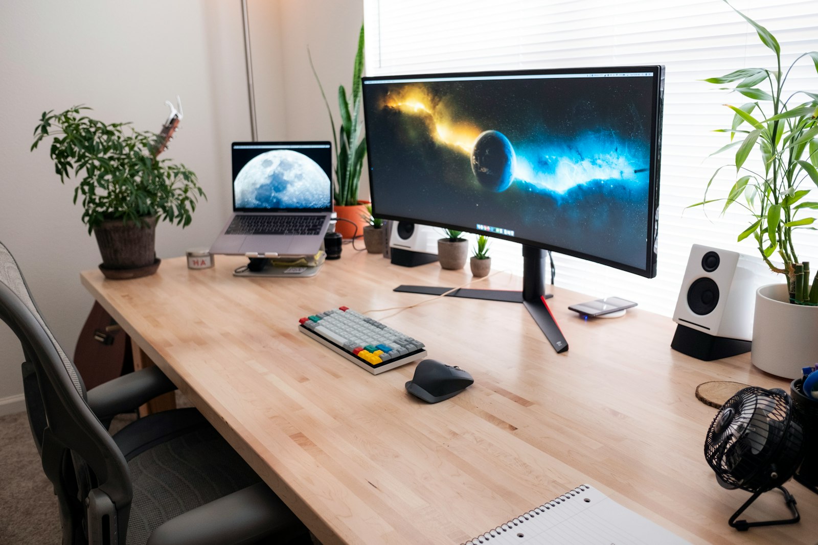 Home office desk with a large monitor set up for remote work