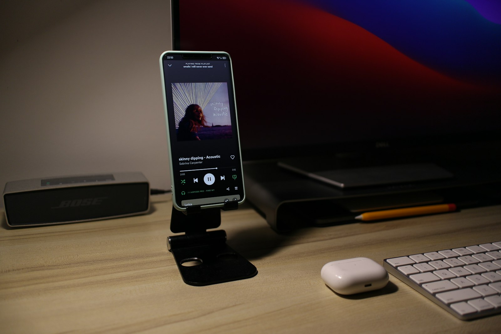 Cell phone sitting on a desk next to a keyboard