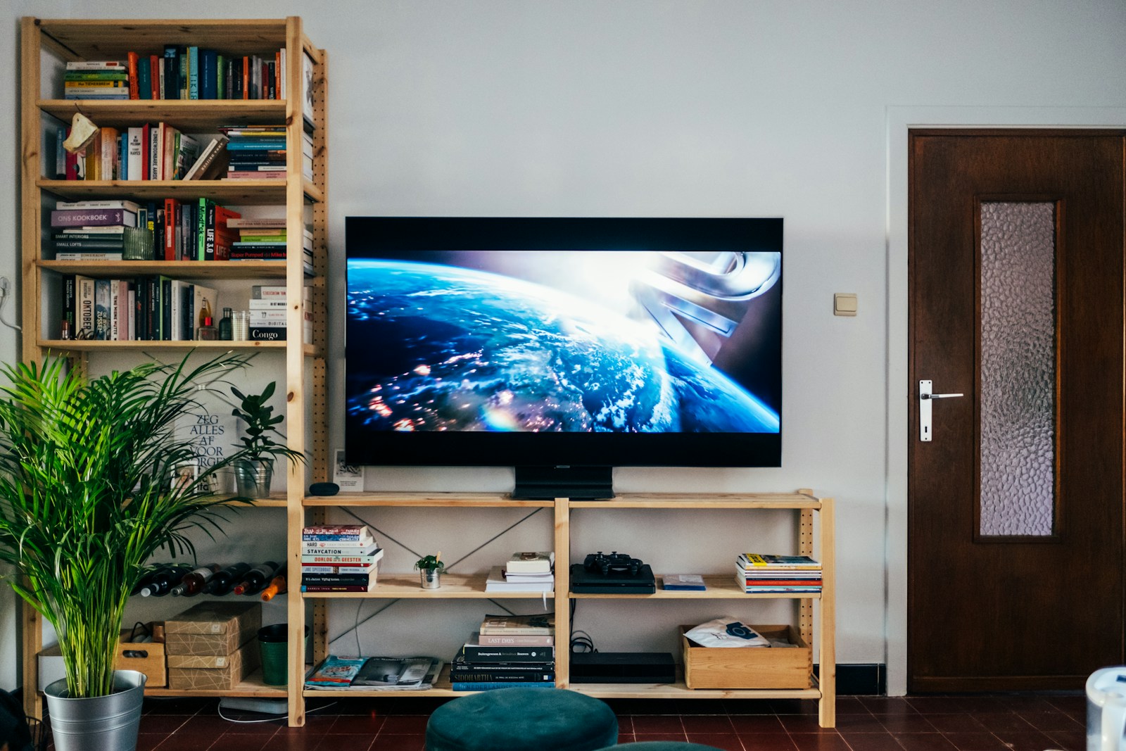 A television on a bookshelf in a living room, where a soundbar would sit beneath the screen