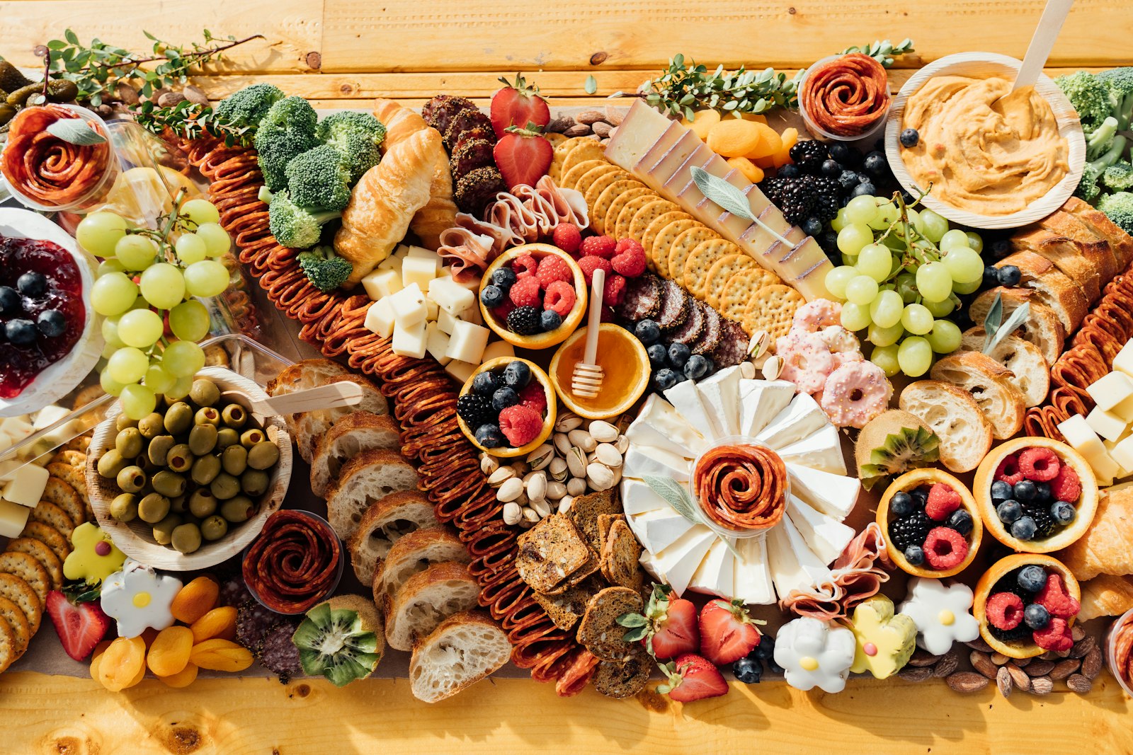 Top-down view of a charcuterie board with cheese, fruit and crackers