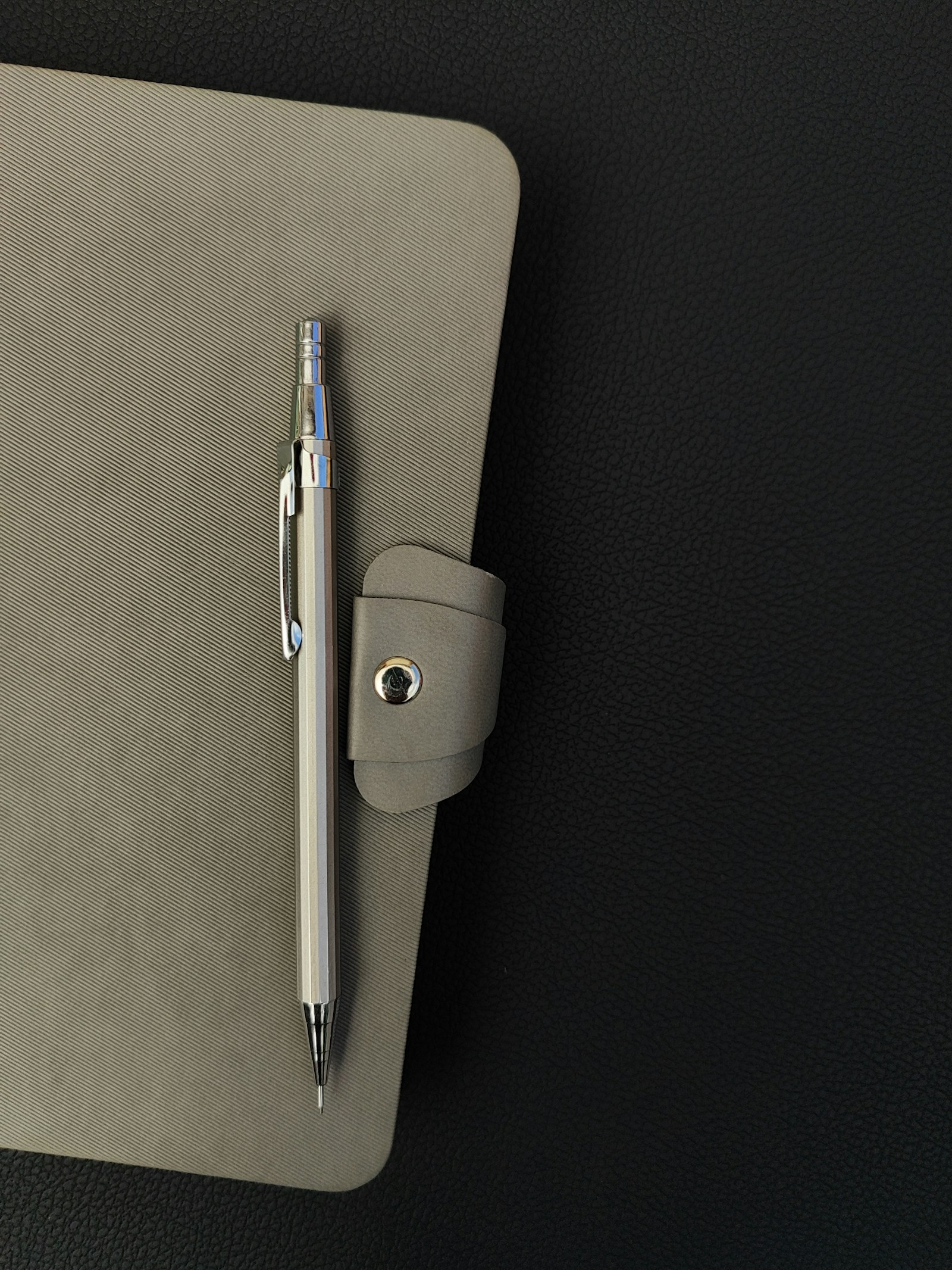 A notepad with a pen on top, illustrating handwritten note-taking