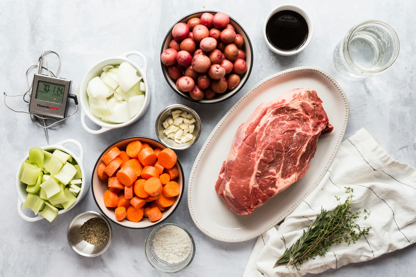 Ingredients for a pot roast beef dinner laid out for slow cooking
