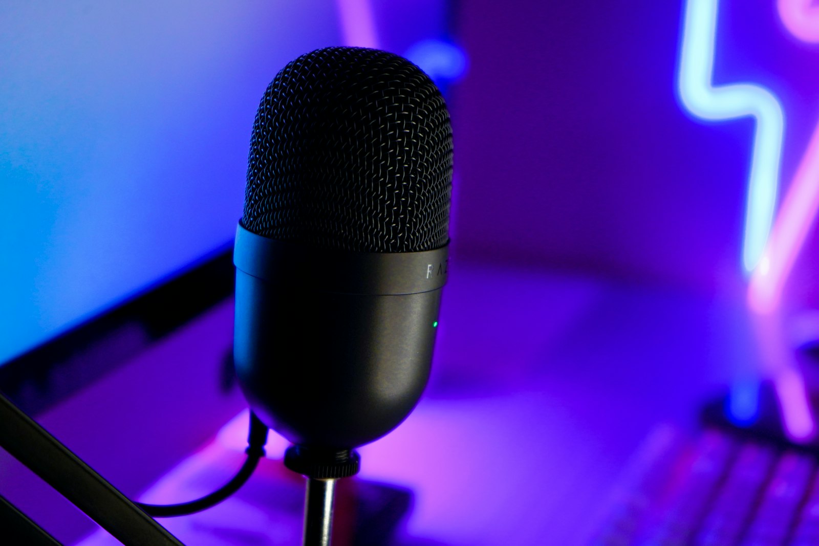 Microphone in front of a laptop on a streaming desk