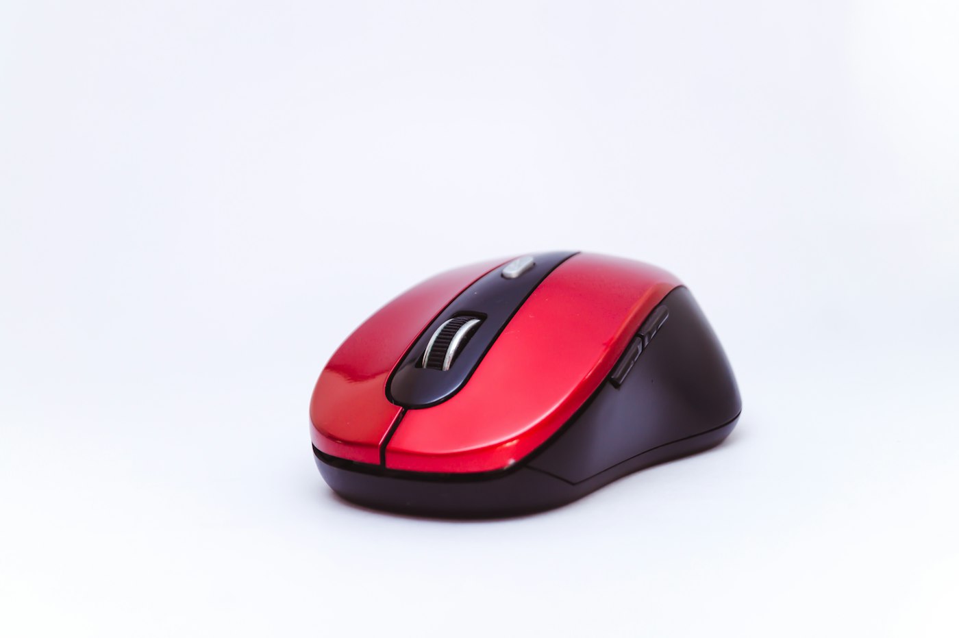 Red and black cordless computer mouse on a white background